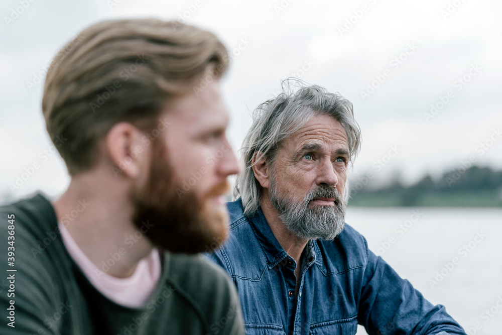 Father and son meeting outdoors, portrait Father and son meeting outdoors, portrait