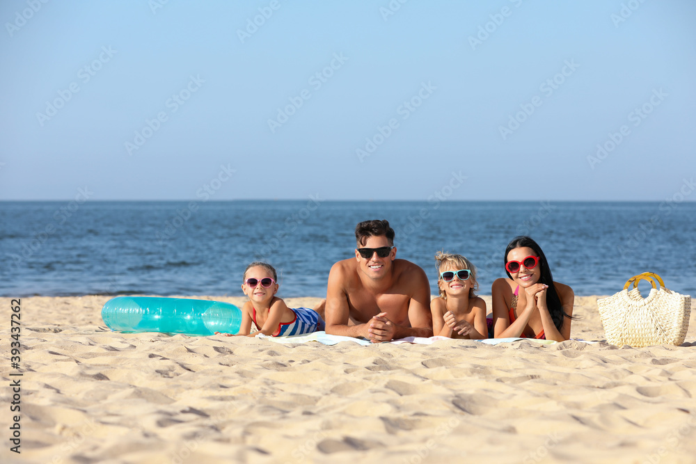 Happy family on sandy beach near sea. Summer holidays Happy family on sandy beach near sea. Summer holidays