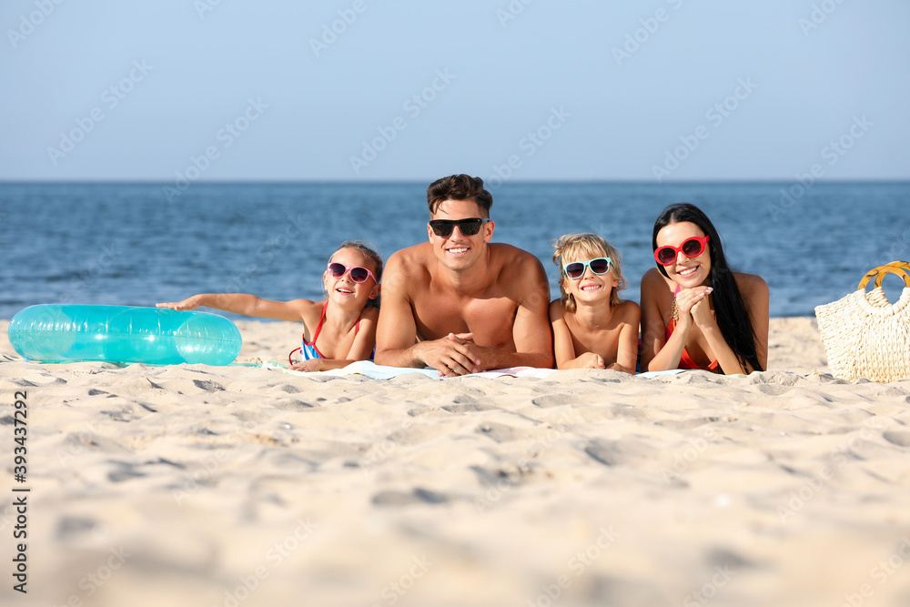Happy family on sandy beach near sea. Summer holidays Happy family on sandy beach near sea. Summer holidays