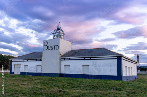 view of the Cabo de Busto lighthouse at sunset photo
