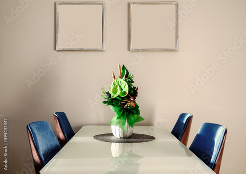 Green Anthurium andraeanum flower setup in a vase on glass dininig table in living room. Air purifying plants in the home decor photo