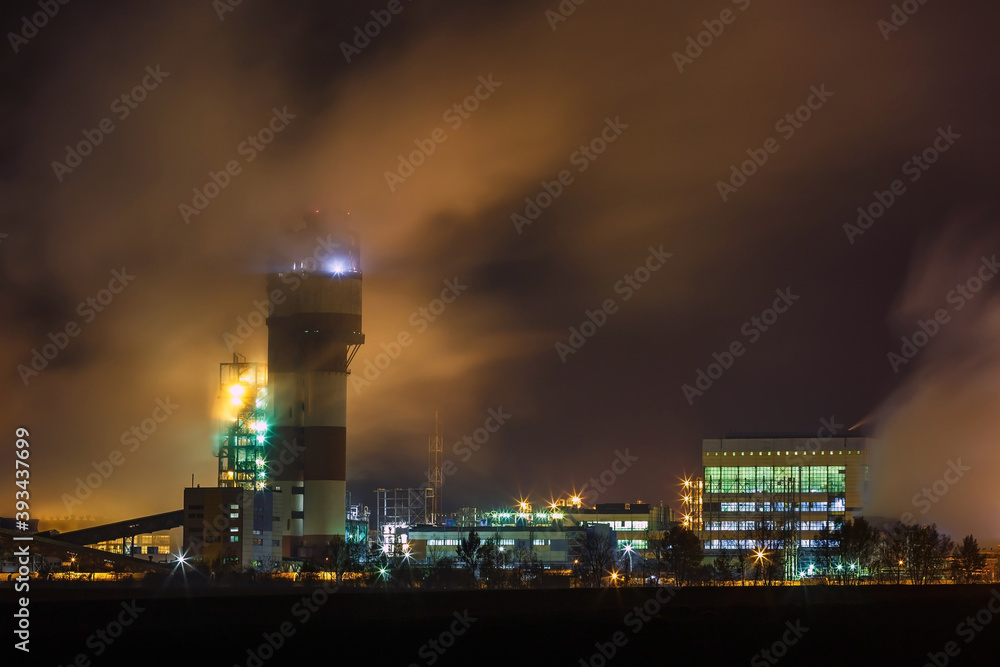 Fototapeta premium night industrial landscape environmental pollution waste of thermal power plant. Big pipes of chemical industry enterprise plant