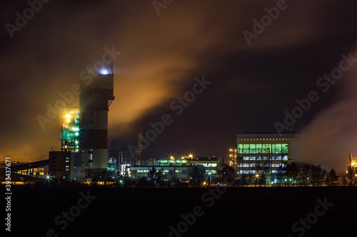 night industrial landscape environmental pollution waste of thermal power plant. Big pipes of chemical industry enterprise plant