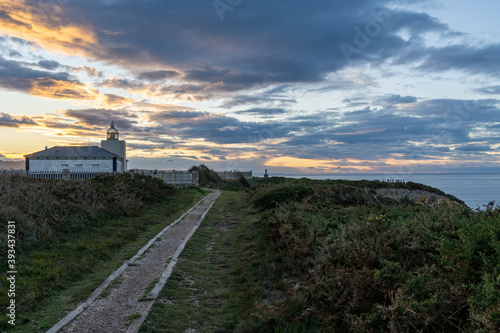 view of the Cabo de Busto lighthouse at sunset photo
