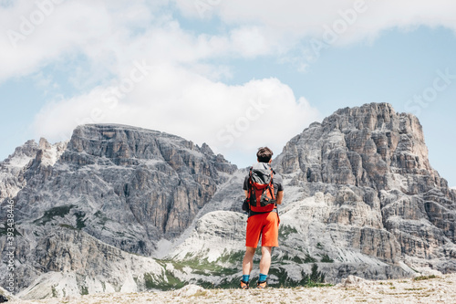 Male tourist looking at famous Tre Cime di Lavaredo against sky, Sesto Dolomites, Dolomites, Alto Adige, Italy