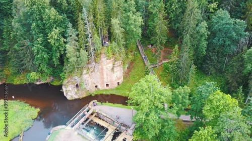 Anfabrika Rocks and Cellars in Ligatne Town an Old Floodgate Dam. Ancient Sandstone Caves and Ancient Chambers in Gauja National Park, Latvia photo