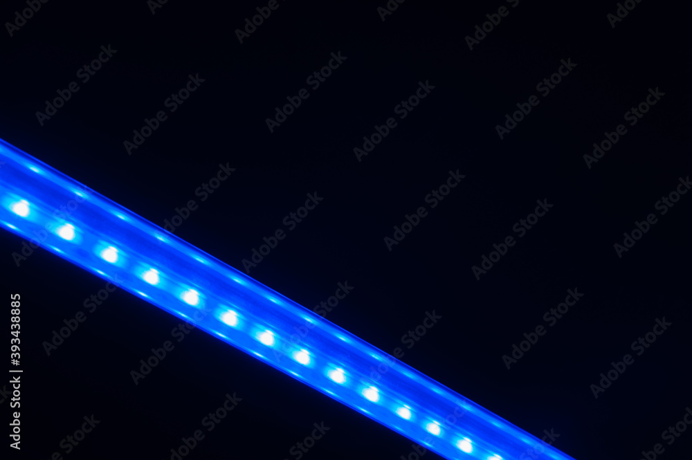 Abstract diagonal blue line of lights in dark.