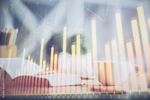 Multi exposure of forex graph drawing and desktop with coffee and items on table background. Concept of financial market trading