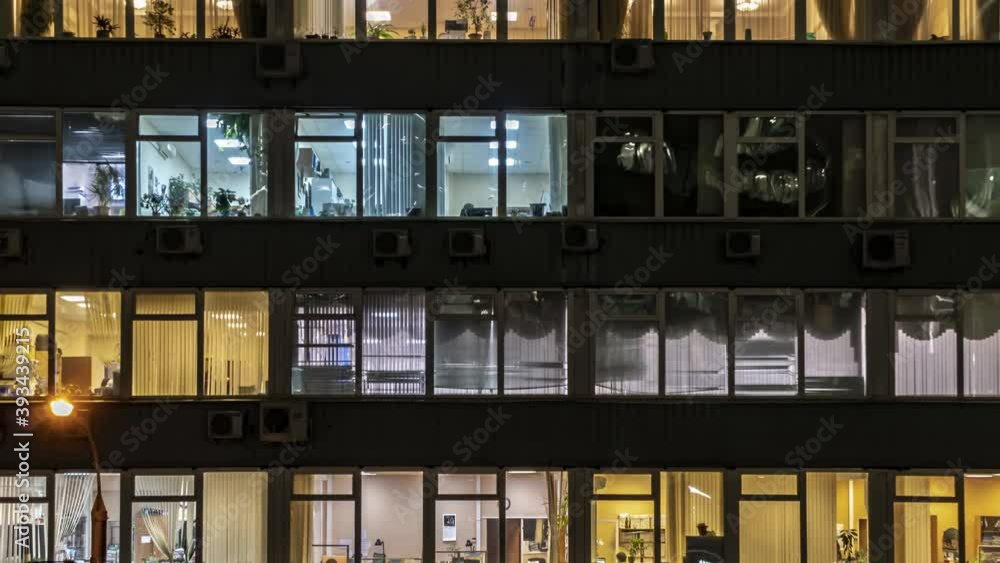 Illuminated windows of offices and business centers in an evening, time lapse Illuminated windows of offices and business centers in an evening, time lapse