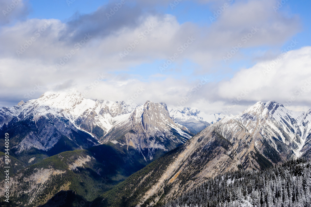 Snow-covered mountains under low clouds.