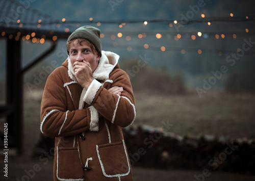 Portrait of happy man smiling outdoors during cold winter day 