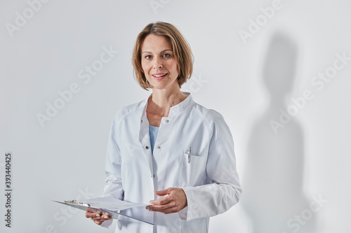 Portrait of female doctor with anamnesis questionnaire