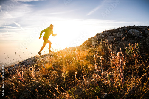 Italy, man running on mountain trail