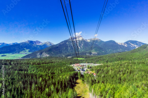 Austria, Tyrol, Ski lift and tourist resort in Wetterstein Mountains during summer photo