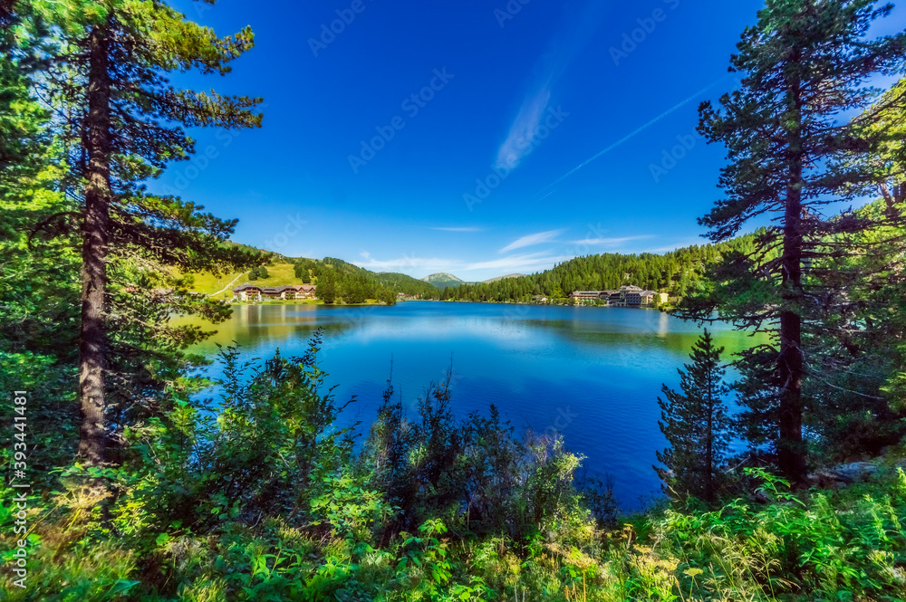 Lake covered with trees and mountain at Turracher Hoehe, Gurktal Alps, Austria Lake covered with trees and mountain at Turracher Hoehe, Gurktal Alps, Austria