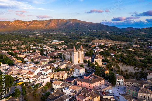 Spain, Mallorca, Calvia, Helicopter view of Parroquia Sant Joan Baptista church and surrounding buildings at dusk photo