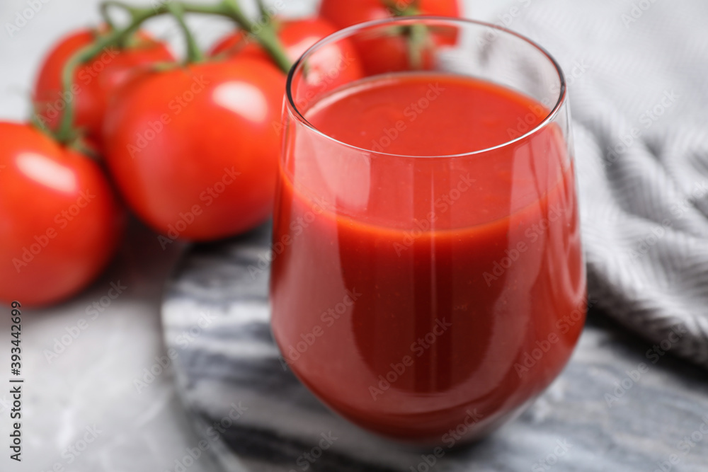Delicious fresh tomato juice in glass on table, closeup Delicious fresh tomato juice in glass on table, closeup