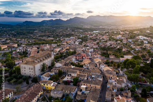 Spain, Mallorca, Calvia, Helicopter view of Parroquia Sant Joan Baptista church and surrounding buildings at sunset photo