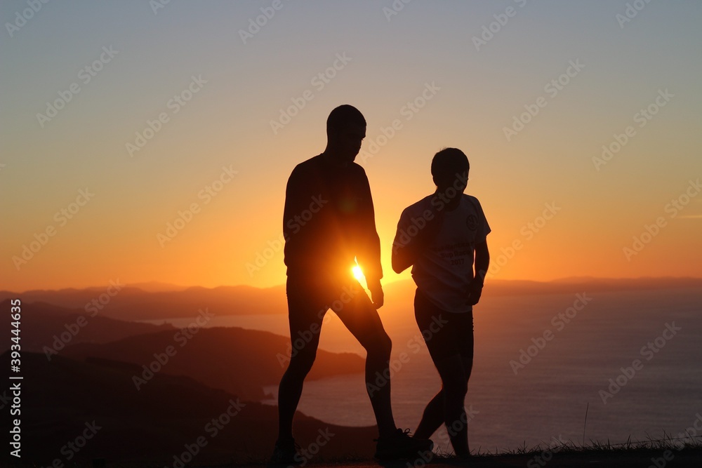silhouette of a couple at sunset in the mountain