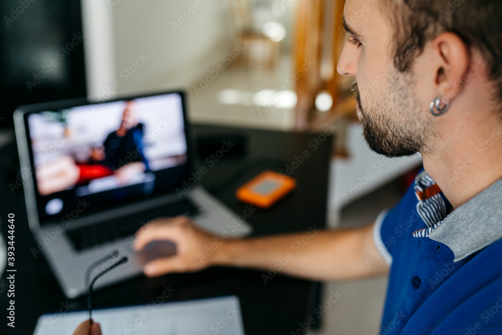 Young man using laptop while studying at home Young man using laptop while studying at home