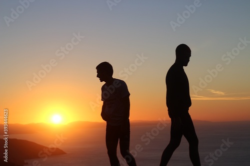 silhouette of a couple at sunset in the mountain © Ainhoa