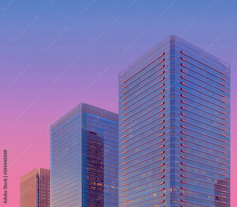 Modern glass skyscraper against sky at dusk, Osaka Modern glass skyscraper against sky at dusk, Osaka