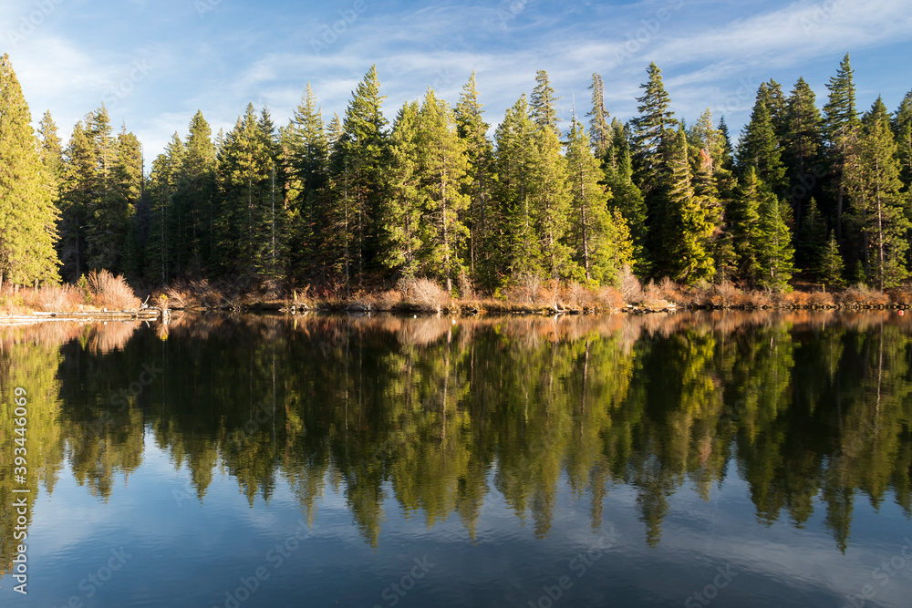 Foliage reflects in calm water of Suttle lake in Oregon