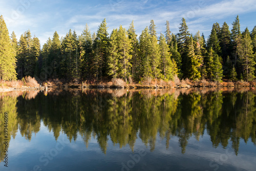 Foliage reflects in calm water of Suttle lake in Oregon