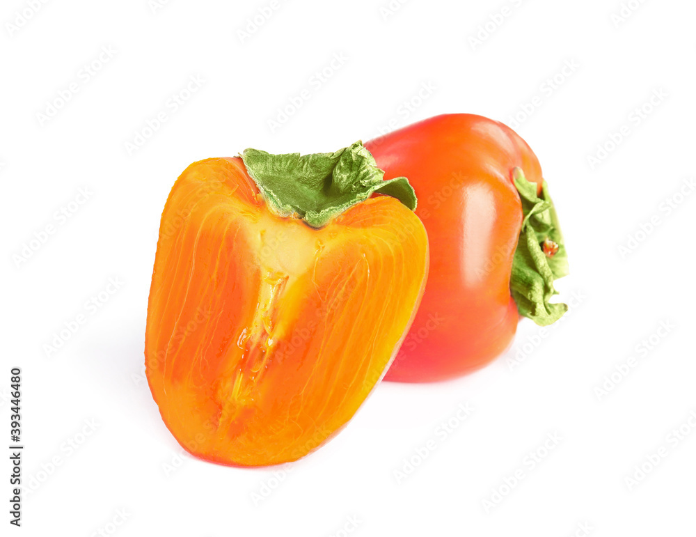 Delicious cut and whole fresh ripe persimmons isolated on white Delicious cut and whole fresh ripe persimmons isolated on white