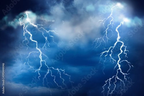 Lightnings in dark cloudy sky during thunderstorm