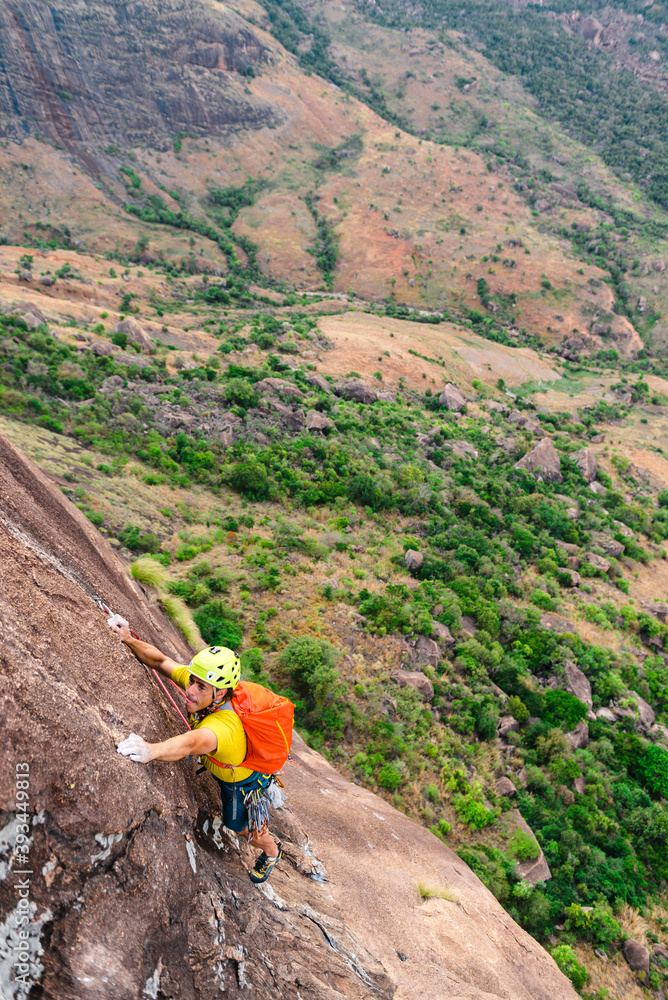 Male mountaineer climbing on cliff in nature Male mountaineer climbing on cliff in nature