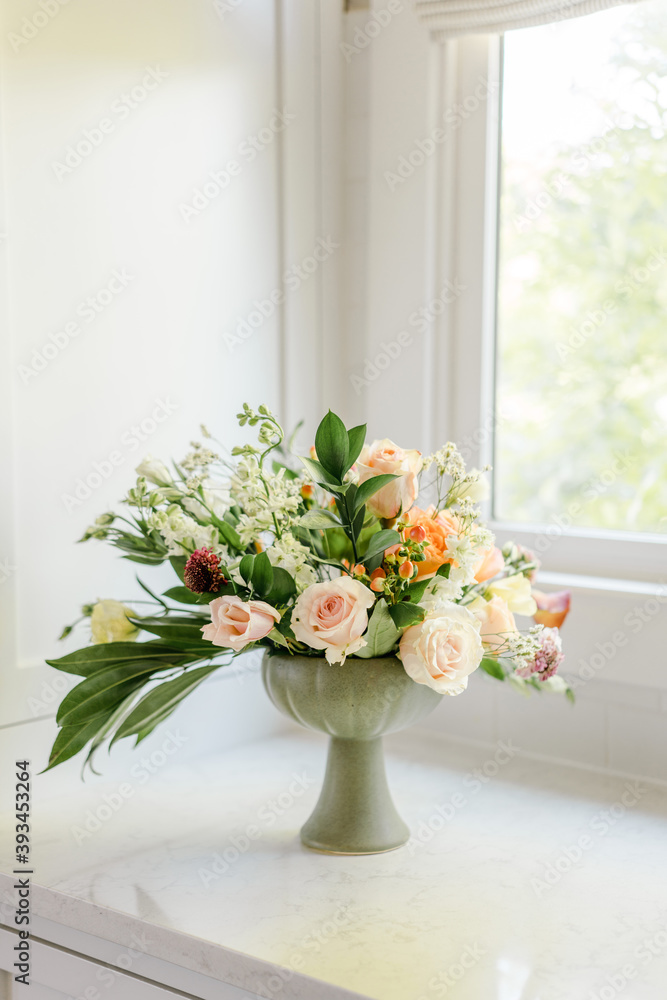 Spring arrangement of roses in green vase Spring arrangement of roses in green vase