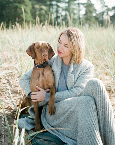 Blonde girl hugs her beloved dog. photo