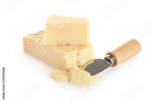 Pieces of Parmesan cheese and knife on white background