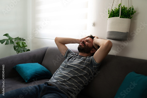 Foto Man with anxiety looking stressed in the sofa
