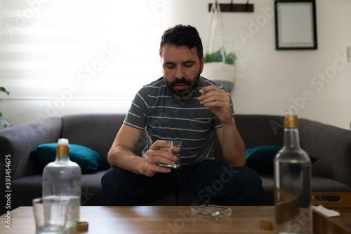 Adult man with addiction problems smoking and drinking
