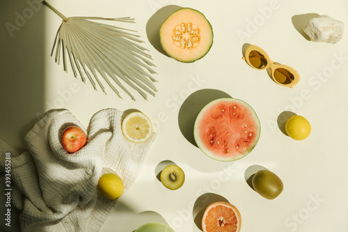 sunny bright flat lay of summer fruit and sunglasses