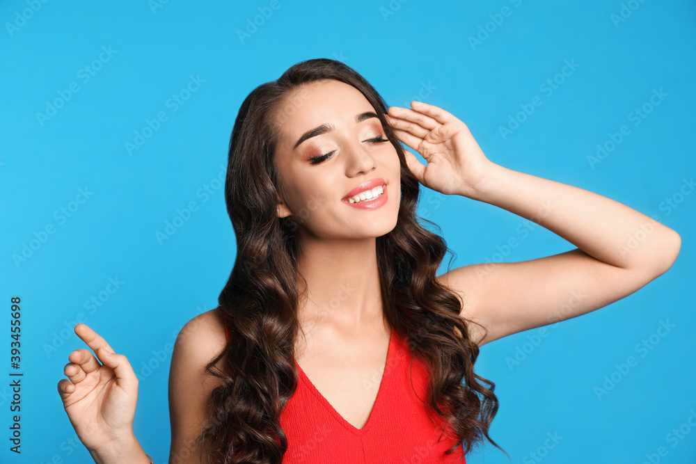 Beautiful young woman on blue background. Christmas party Beautiful young woman on blue background. Christmas party