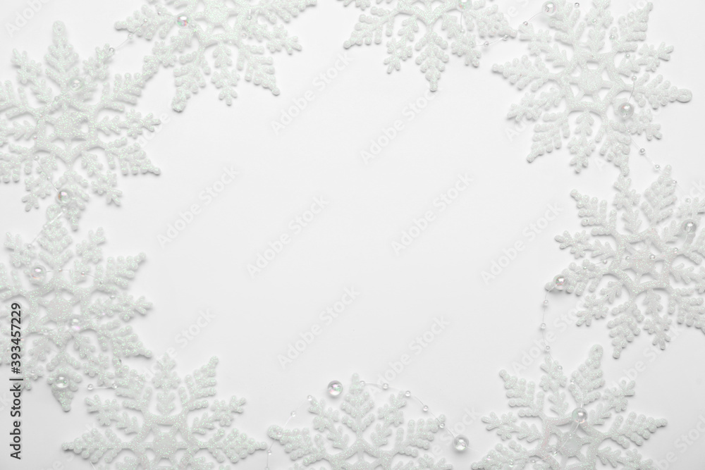 Fototapeta premium Beautiful decorative snowflakes on white background, flat lay. Space for text