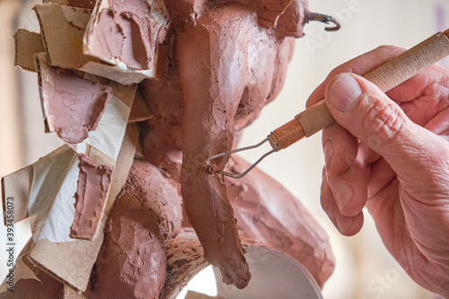 sculptor modeling in clay