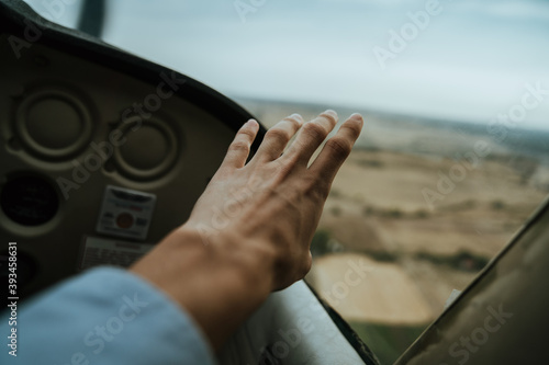 Hand on the window from the view of a small plane