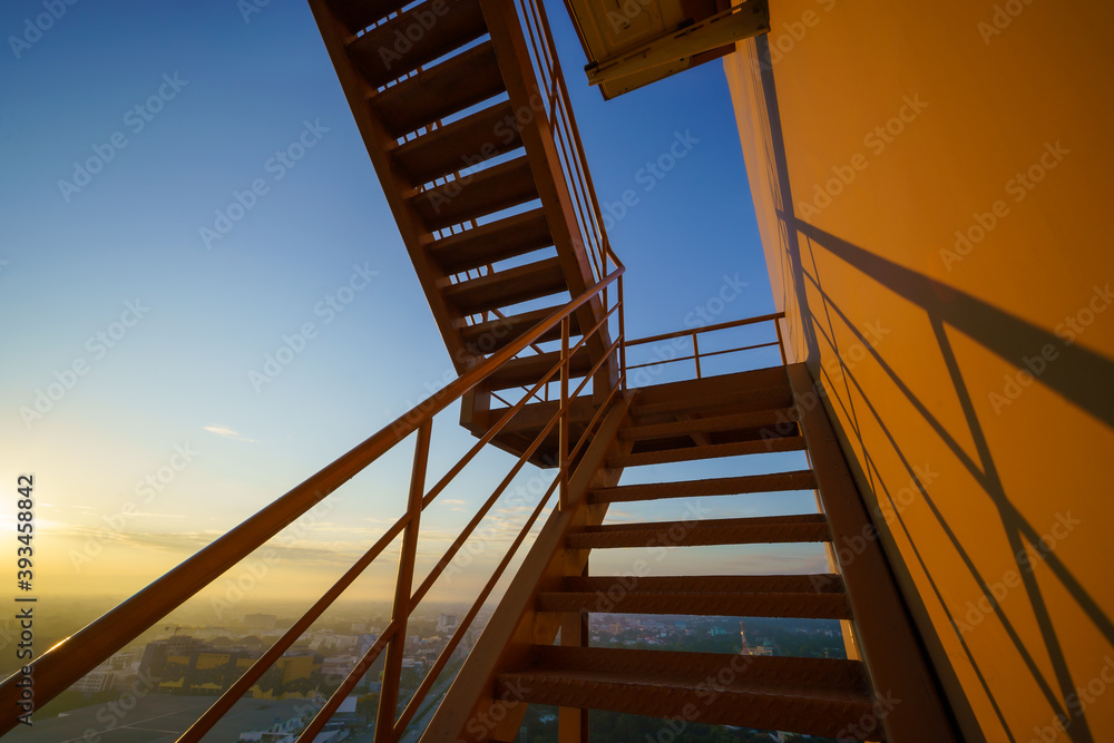 Fire escape on the yellow building wall, Outside fire escape stairs.Emergency exit with yellow wall.. Fire escape on the yellow building wall, Outside fire escape stairs.Emergency exit with yellow wall..