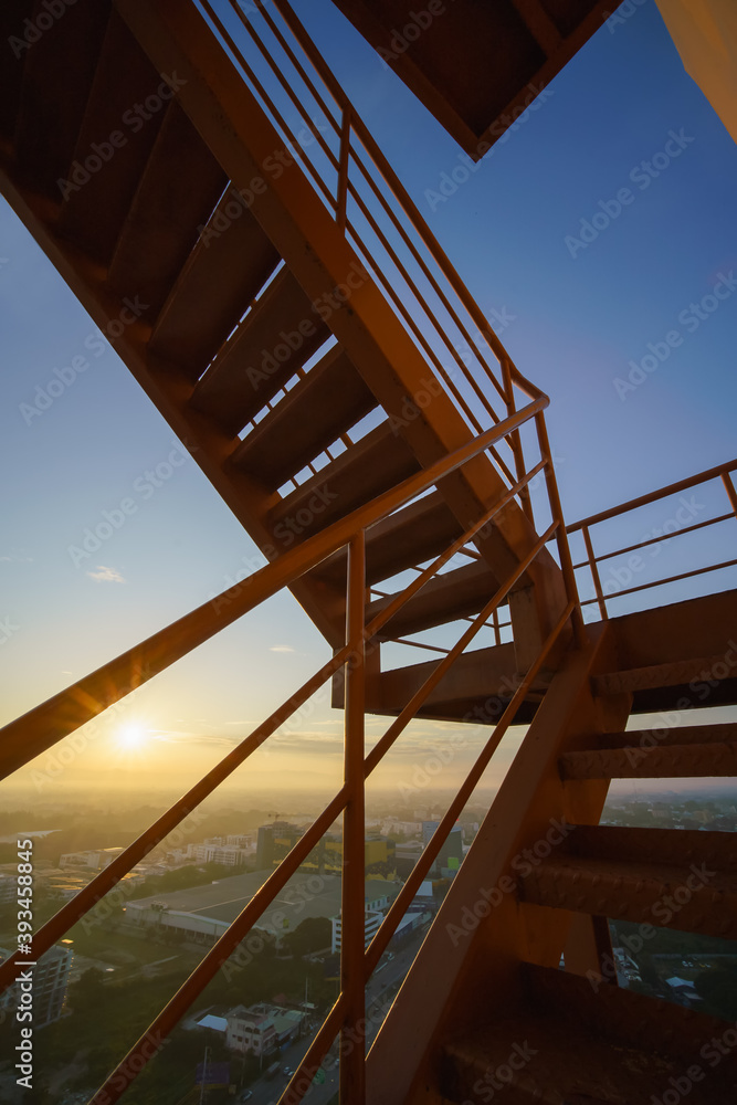 Fire escape on the yellow building wall, Outside fire escape stairs.Emergency exit with yellow wall.. Fire escape on the yellow building wall, Outside fire escape stairs.Emergency exit with yellow wall..