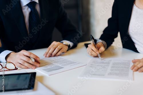 Anonymous business partners signing contract during meeting photo