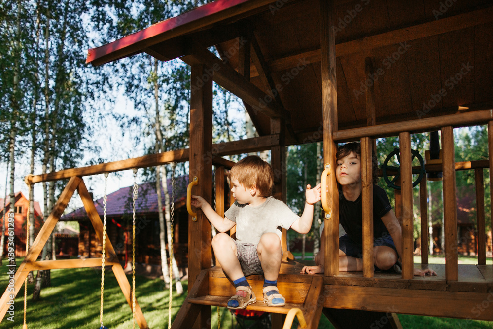 Little brothers are bored outdoor. Little brothers are bored outdoor.