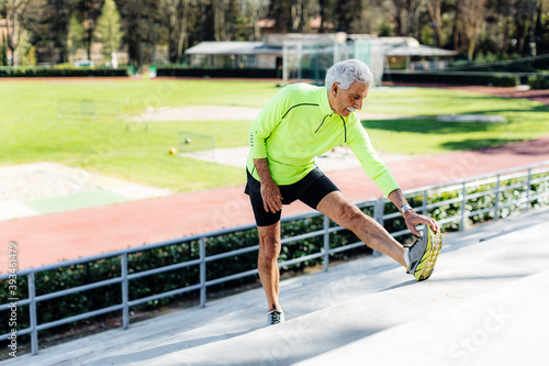 Senior sportsman warming up during training