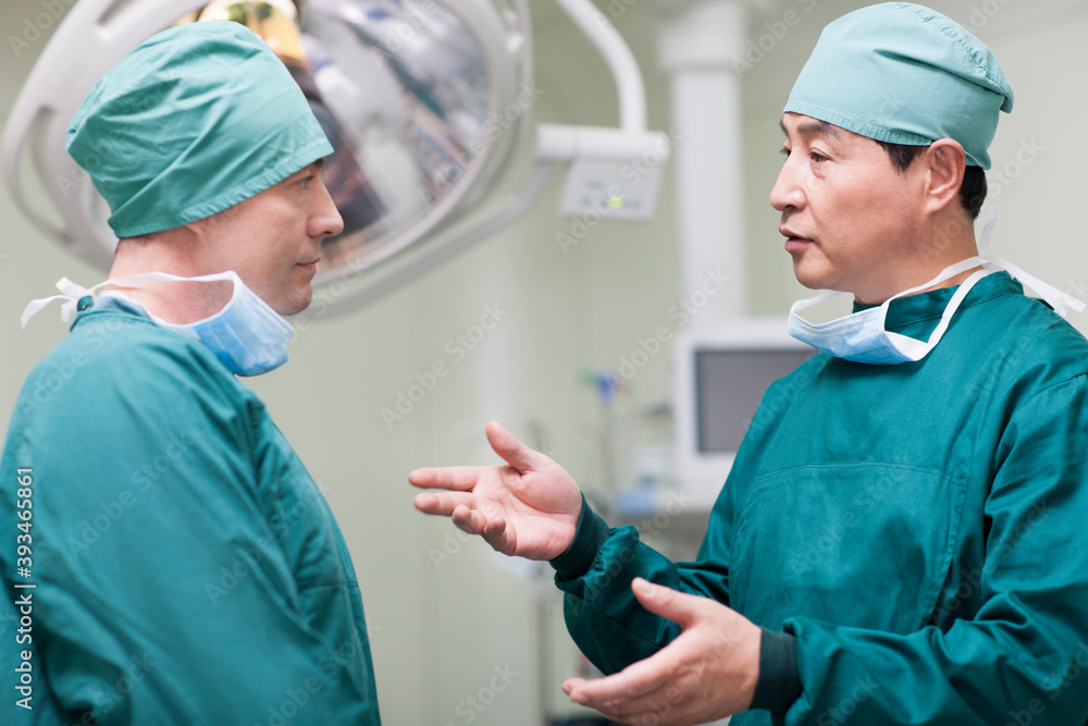 Surgeons talking in operating room Surgeons talking in operating room