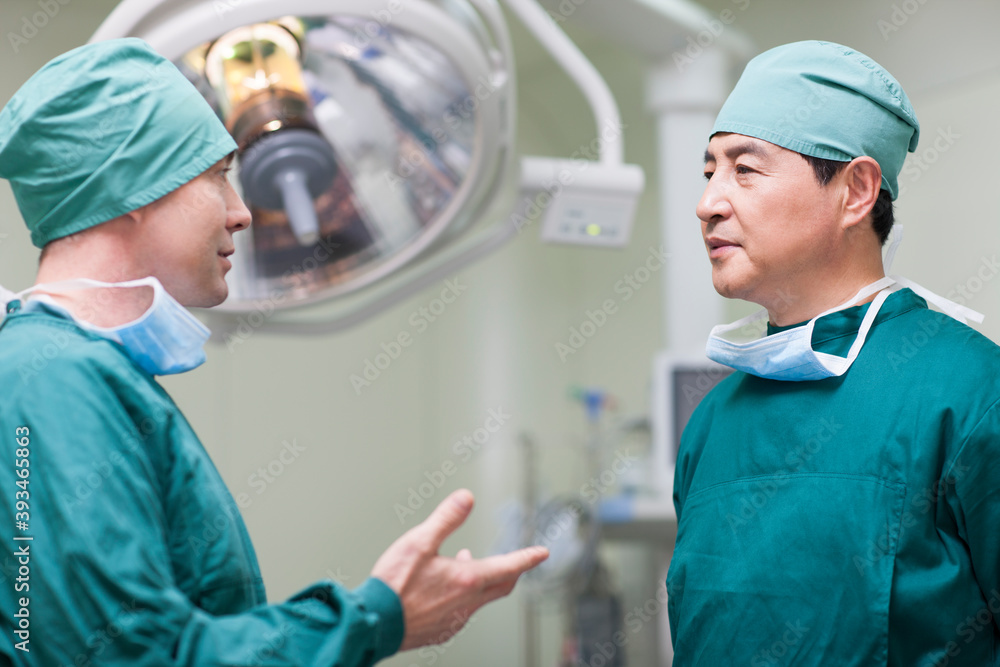 Surgeons talking in operating room
