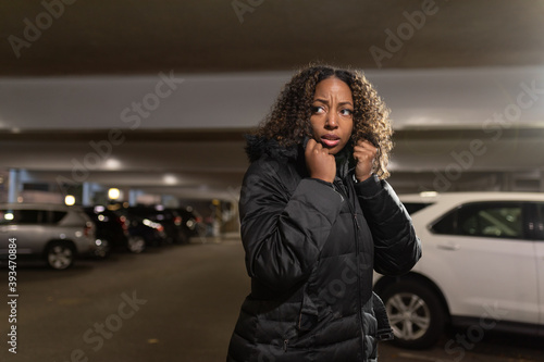 African-american woman fearful in parking structure