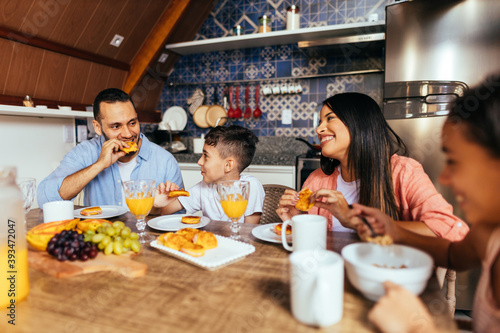 Latin family eating healthy breakfast in the kitchen
